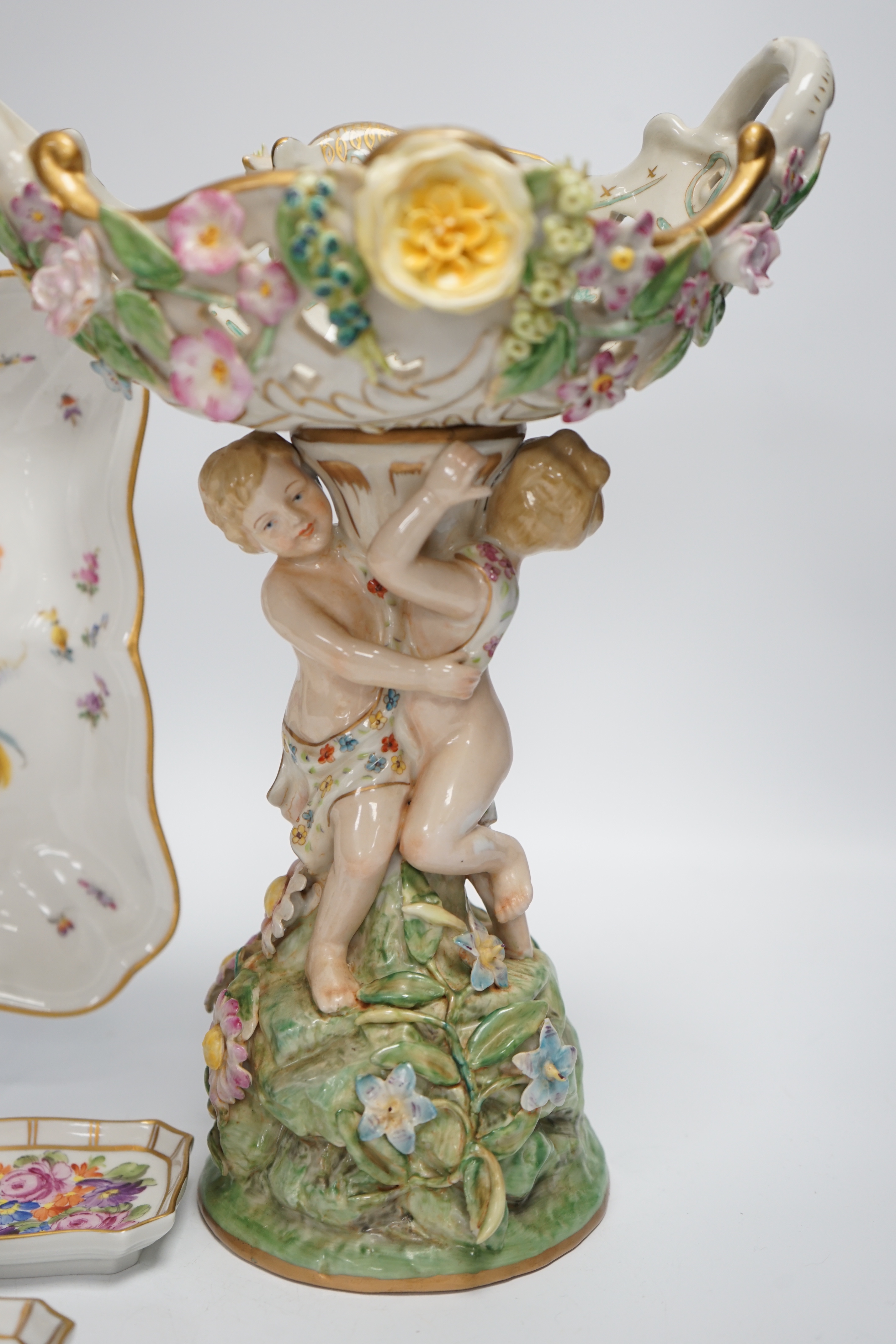 A German porcelain figural centrepiece, a Meissen floral dish, and various Dresden dishes, tallest 29cm